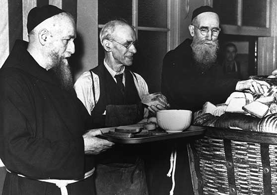 Fr. Solanus along with other friars and volunteers, serving in the Capuchin Soup Kitchen.