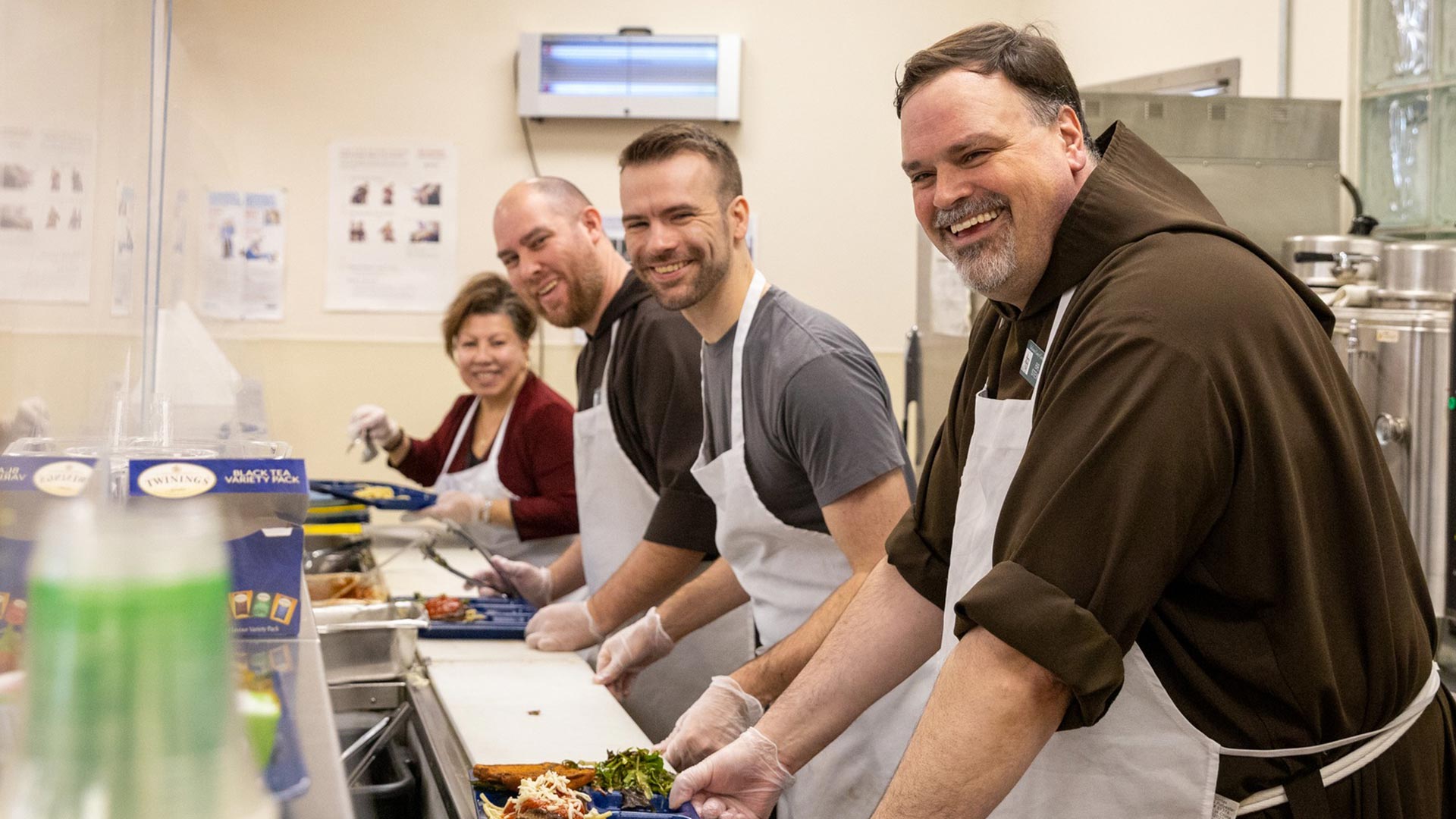 Br. Steve Kropp and volunteers serve the meal at the Capuchin Soup Kitchen.